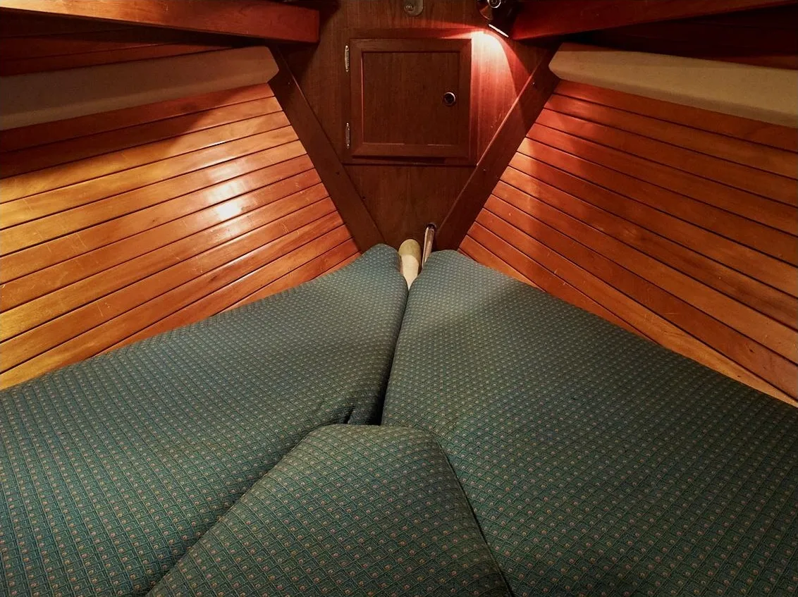 The forepeak could be arranged like a traditional V-berth, but some owners opted for a pullman berth—or storage shelf and additional lockers.