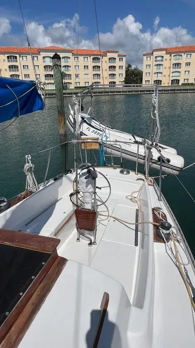 The cockpit layout is typical of 1970s design with adequate space but lacking modern conveniences like scuppers that drain completely. The original winches are undersized, so we suggest beefing them up for easier genoa trimming. Courtesy of Yachtworld.com