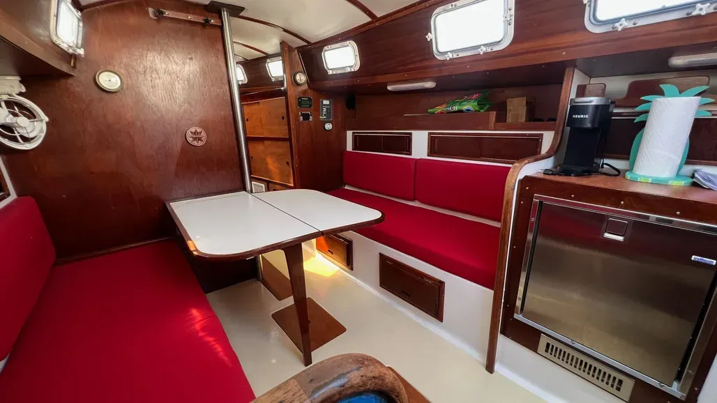 The main cabin design is efficient use of space with settees that double as sea berths. Storage under the settees is generous since tanks are located in the stern and bow, though the lack of a navigation station is a notable omission by today's standards. Courtesy of Yachtworld.com