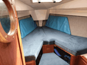 The V-berth is situated far forward to maximize space, but that makes the foot of the berth narrow. The extended cabin trunk provides good headroom over the berth, but standing room does drop below 6 feet. Courtesy of Yachtworld.com