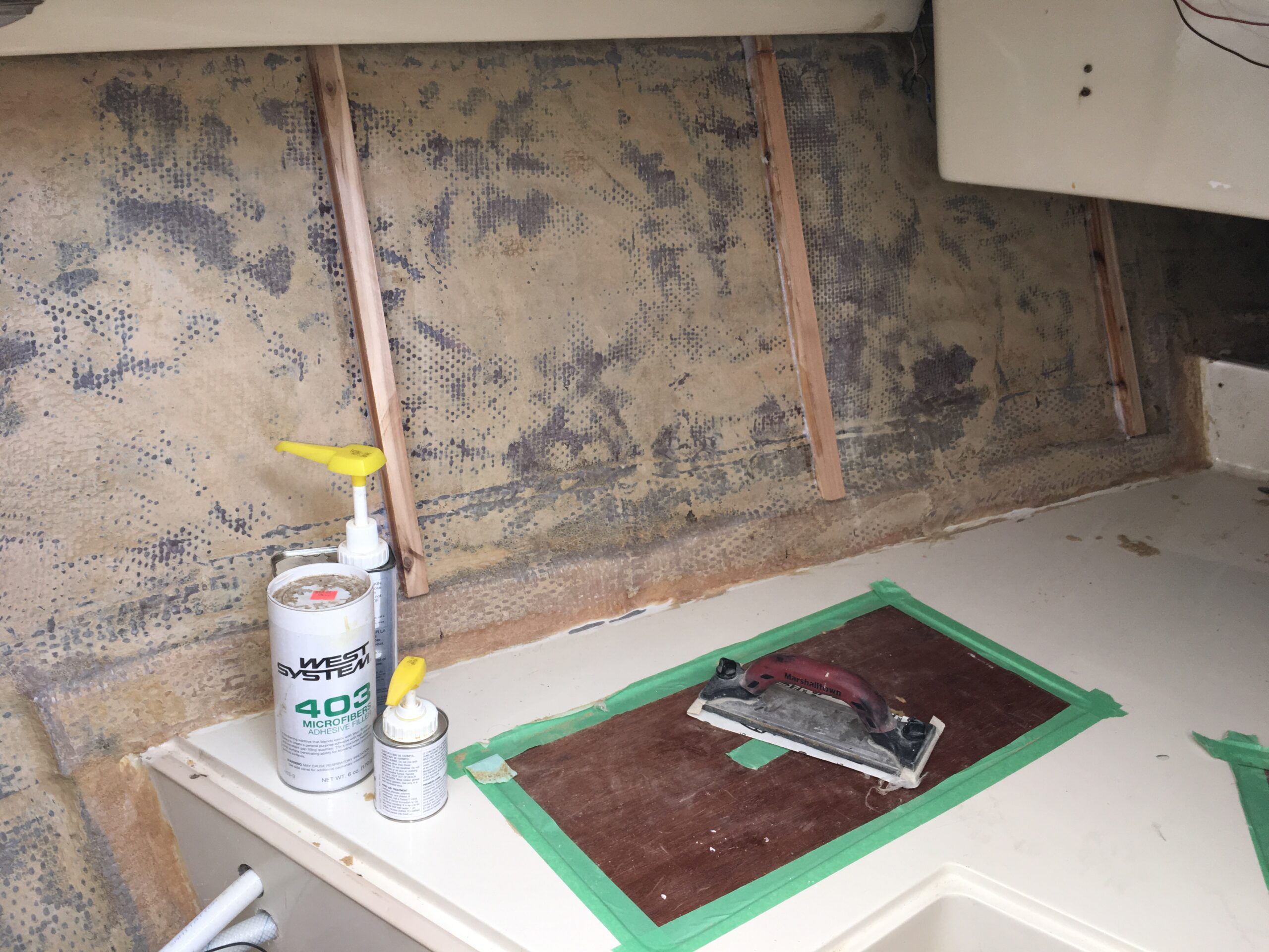 The original foam backing removed, ground away with a sanding disk on an angle grinder. Beware of the dust storm! Then I installed the cedar ribs with West System epoxy and filler. (Photo/ Bert Vermeer)