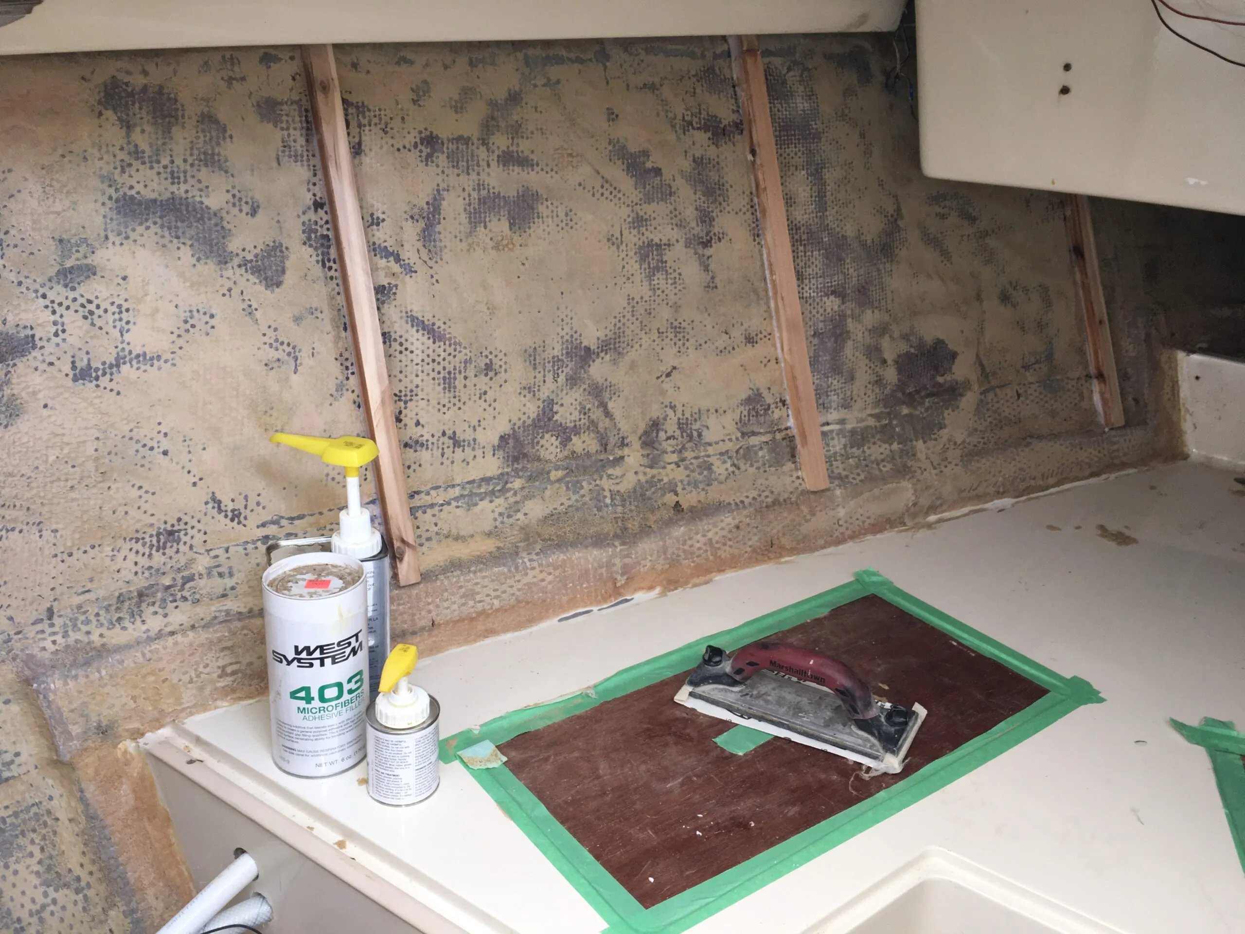 The original foam backing removed, ground away with a sanding disk on an angle grinder. Beware of the dust storm! Then I installed the cedar ribs with West System epoxy and filler. (Photo/ Bert Vermeer)