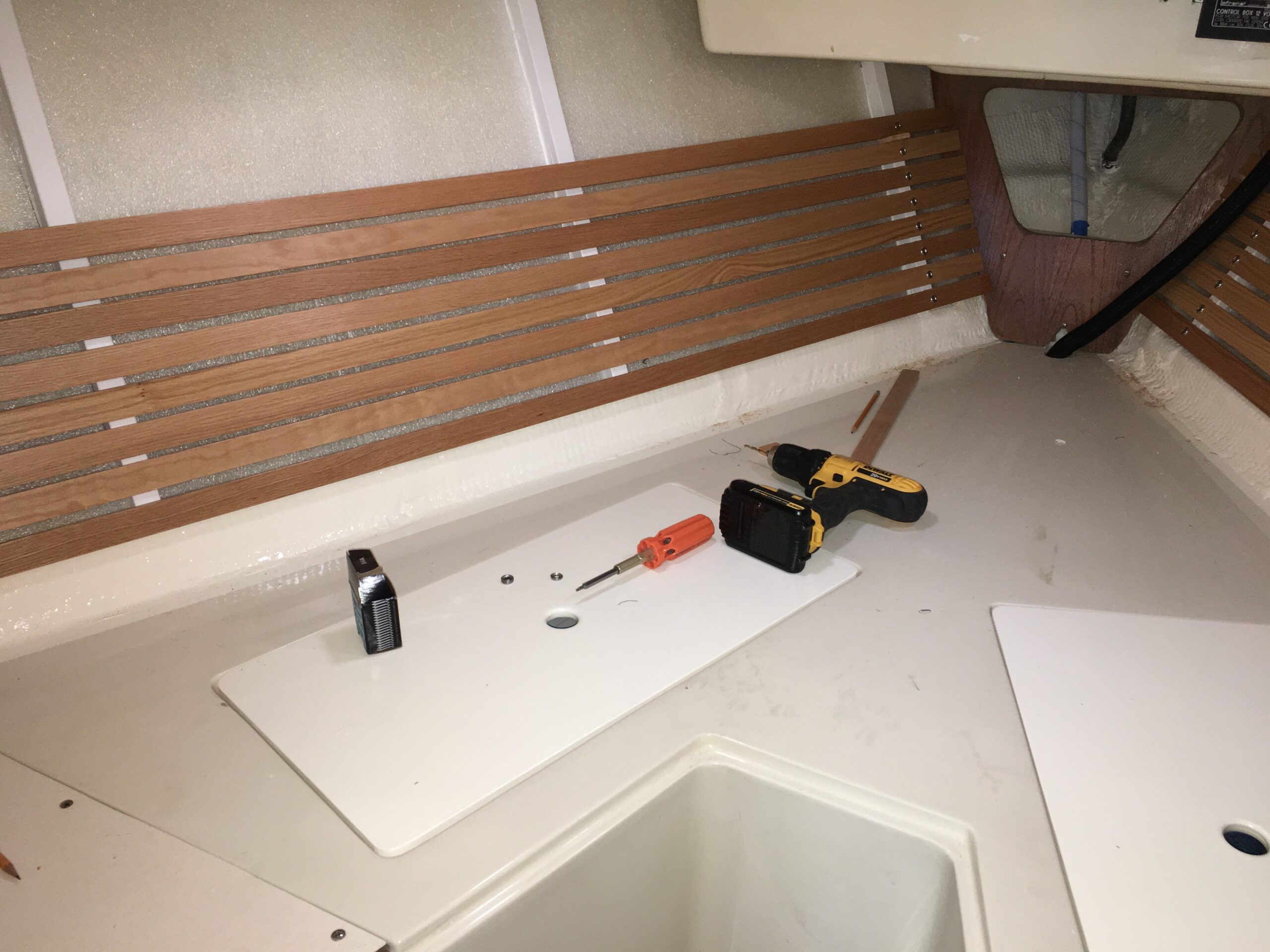 Installing the oak strips onto the ribs with ½” # 6 stainless steel screws. (Photo/ Bert Vermeer)