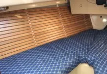 The finished product gleams. After removing moldy fabric, prepping the surface and installing closed cell foam and wood strips, this V-berth has a fresh, functional new look. (Photo/ Bert Vermeer)