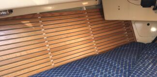 The finished product gleams. After removing moldy fabric, prepping the surface and installing closed cell foam and wood strips, this V-berth has a fresh, functional new look. (Photo/ Bert Vermeer)