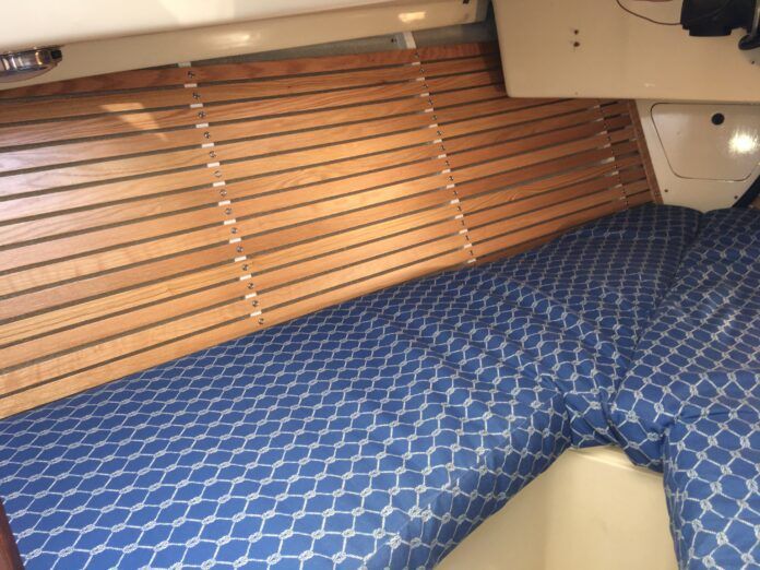 IMG_1819 The finished product gleams. After removing moldy fabric, prepping the surface and installing closed cell foam and wood strips, this V-berth has a fresh, functional new look. (Photo/ Bert Vermeer)