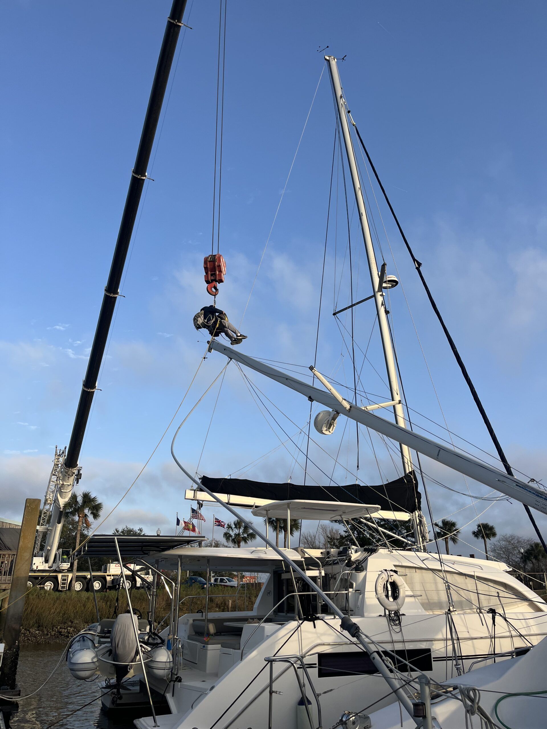 The crane positioned in the parking lot could barely extend out to just reach the mast. (Photo/ Alex Jasper)