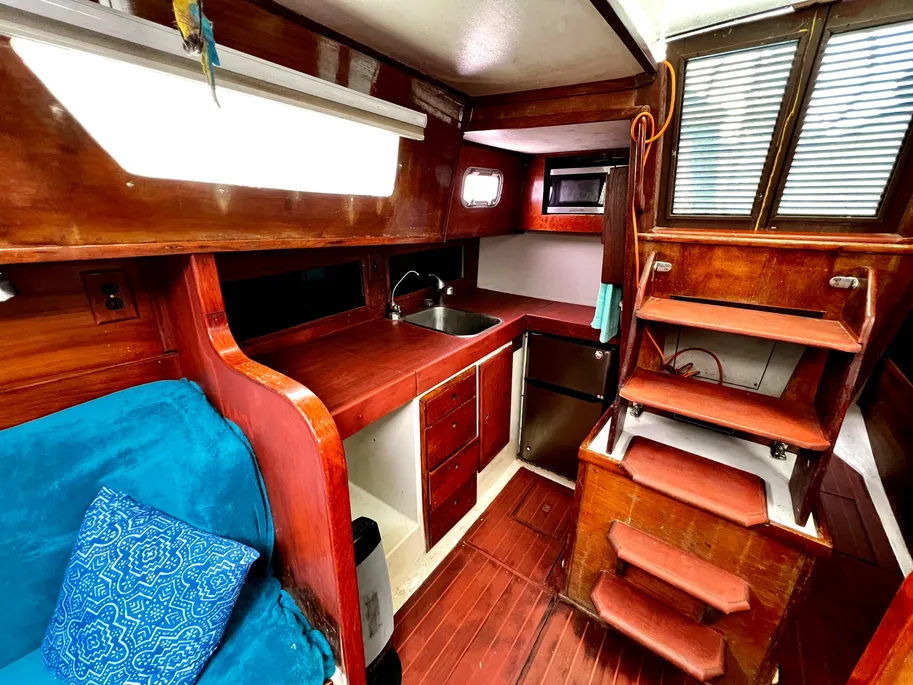 The step-down galley features both a front-opening Norcold refrigerator and large top-opening iceboxes, providing exceptional cold storage capacity. Courtesy of Yachtworld.com