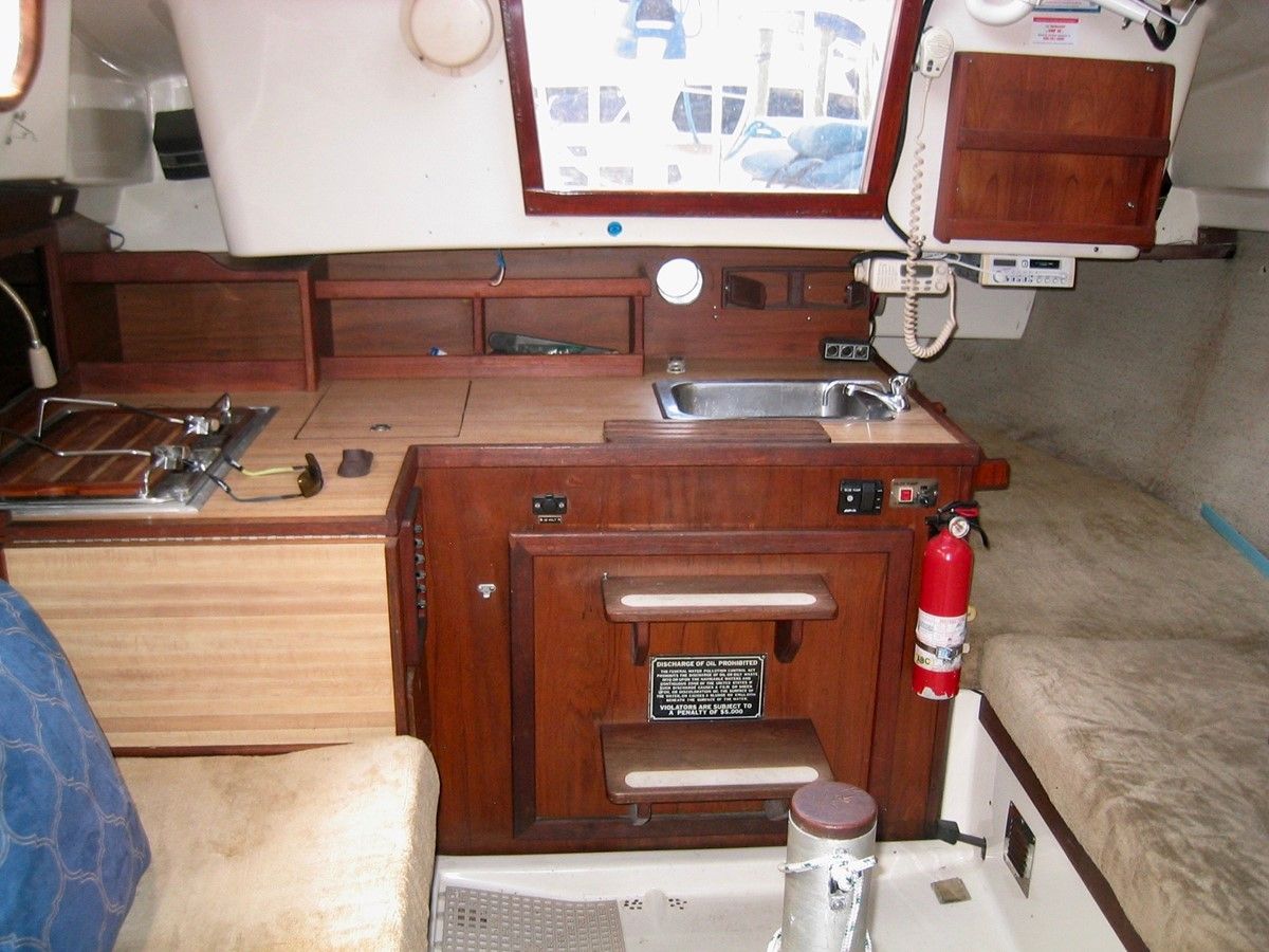 While having the kitchen sink located in line with the companionway steps is not ideal, some concessions need to be made to fit in all the essentials in a small boat. Courtesy of Yatco.com