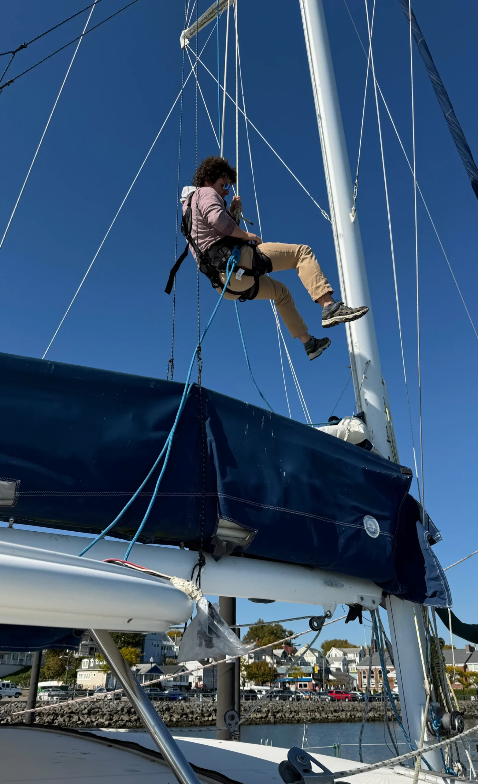 Oliver going up the mast on Confianza in the CMC Atom Global Harness, feeling comfortable and confident. (Photo/ Adam Morris)