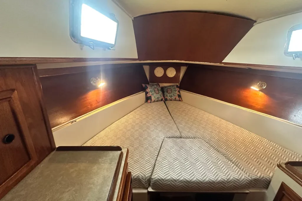 The V-berth provides another queen-sized sleeping area with private head access. Good ventilation via the duck hatches and spacious accommodations make this an excellent cabin for guests or family. Courtesy of YachtWorld.com