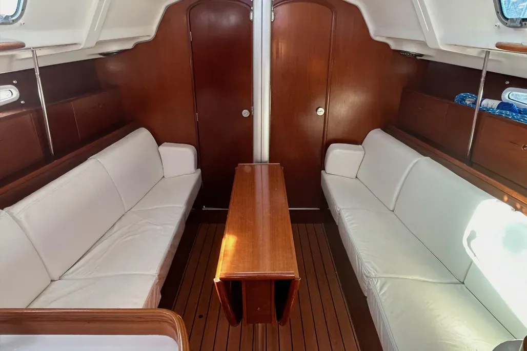 The 36.7's traditional-style interior provides seating for six in the saloon, with 6-ft. 2-in. headroom and settees that convert to berths. The removable stainless steel table support doubles as a foot brace for crew when underway and creates space for sail storage during racing. Courtesy of YachtWorld.com
