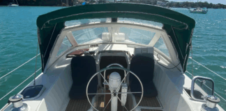 The center cockpit layout places the helmsperson high above the waterline, offering excellent visibility during anchoring and maneuvering. The cockpit's compact size—seating only three in real comfort—reflects her offshore cruising priorities over entertaining. Courtesy of Yachtworld.com