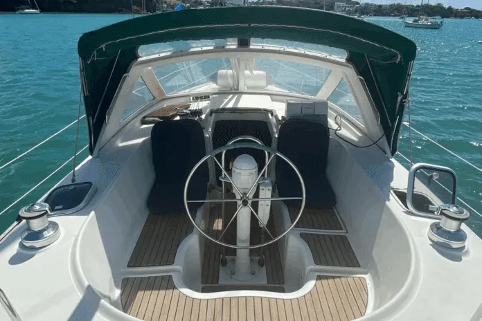 The center cockpit layout places the helmsperson high above the waterline, offering excellent visibility during anchoring and maneuvering. The cockpit's compact size—seating only three in real comfort—reflects her offshore cruising priorities over entertaining. Courtesy of Yachtworld.com