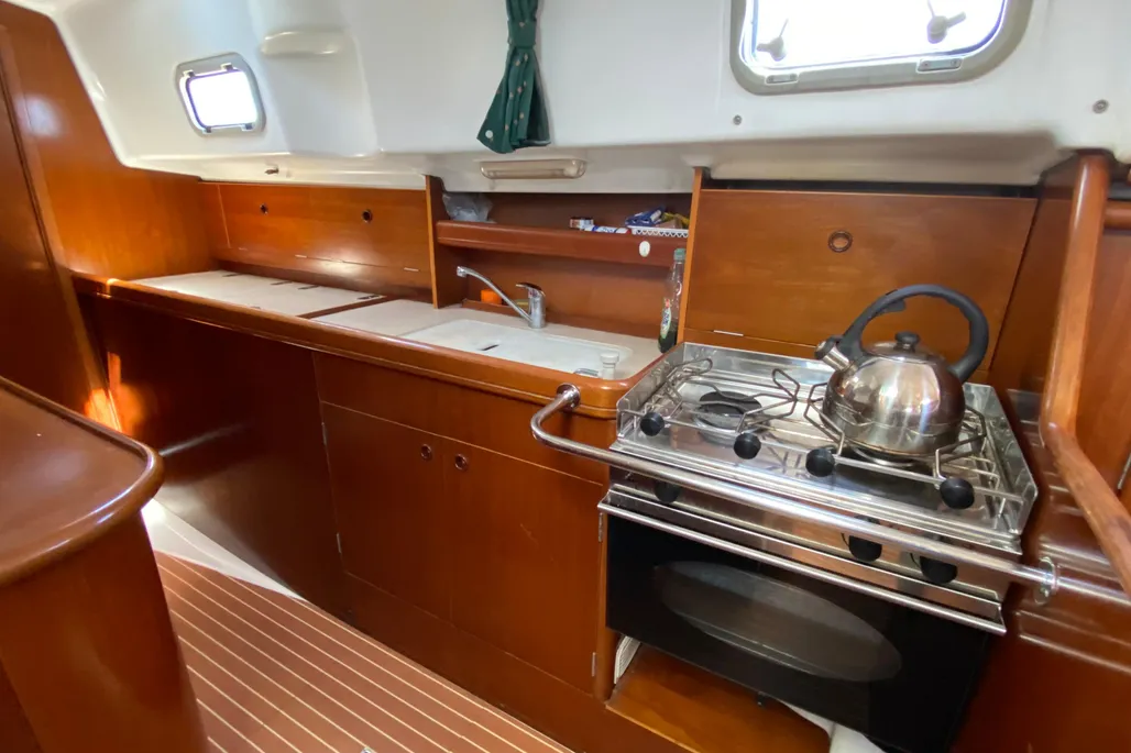 Six feet of galley counter space runs along the port side outboard of the main companionway. The L-shaped layout keeps the cook secure at sea while providing ample work surface and good natural light from the adjacent hull ports. Courtesy of Yachtworld.com