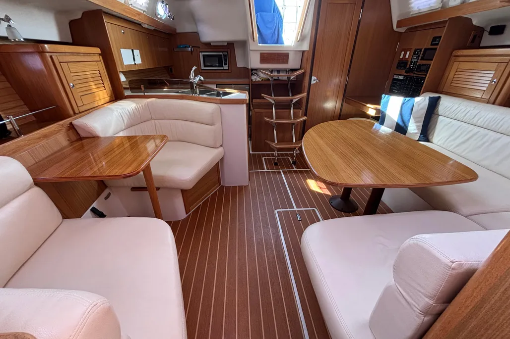 The teak-finished saloon offers improved headroom and ventilation over the earlier 36, with solid joinery and well-placed handholds for security underway. The Lonseal synthetic sole provides good traction and easy upkeep. Courtesy of Yachtworld.com
