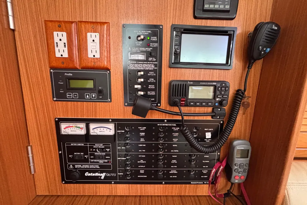The compact, outboard-facing navigation station is logically arranged with a clean AC/DC panel. While space for full-size charts is limited, it suits coastal cruising needs and keeps controls within easy reach. Courtesy of Yachtworld.com