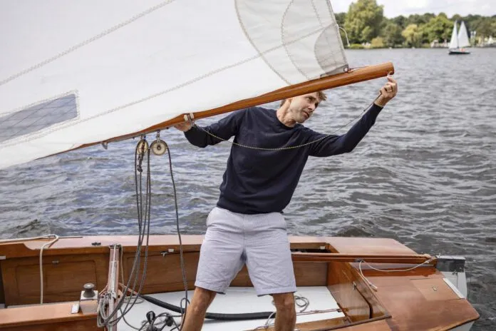 Man preparing yacht for a sailing trip Take the stress out of buying your first sailboat by preparing for all of the costs and processes ahead of time.