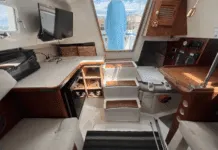 The Hunter 27 maximizes volume below with a just-over-six-foot headroom beneath the main hatch, teak trim, and a practical galley. Courtesy of BoatTrader.com