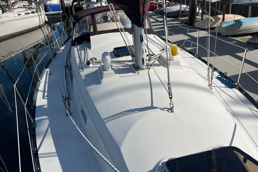 Solid fiberglass construction with bolted lead ballast has proven durable over four decades, though deck gelcoat typically shows age-related crazing that rarely affects structural integrity. Photo courtesy of YachtWorld.com