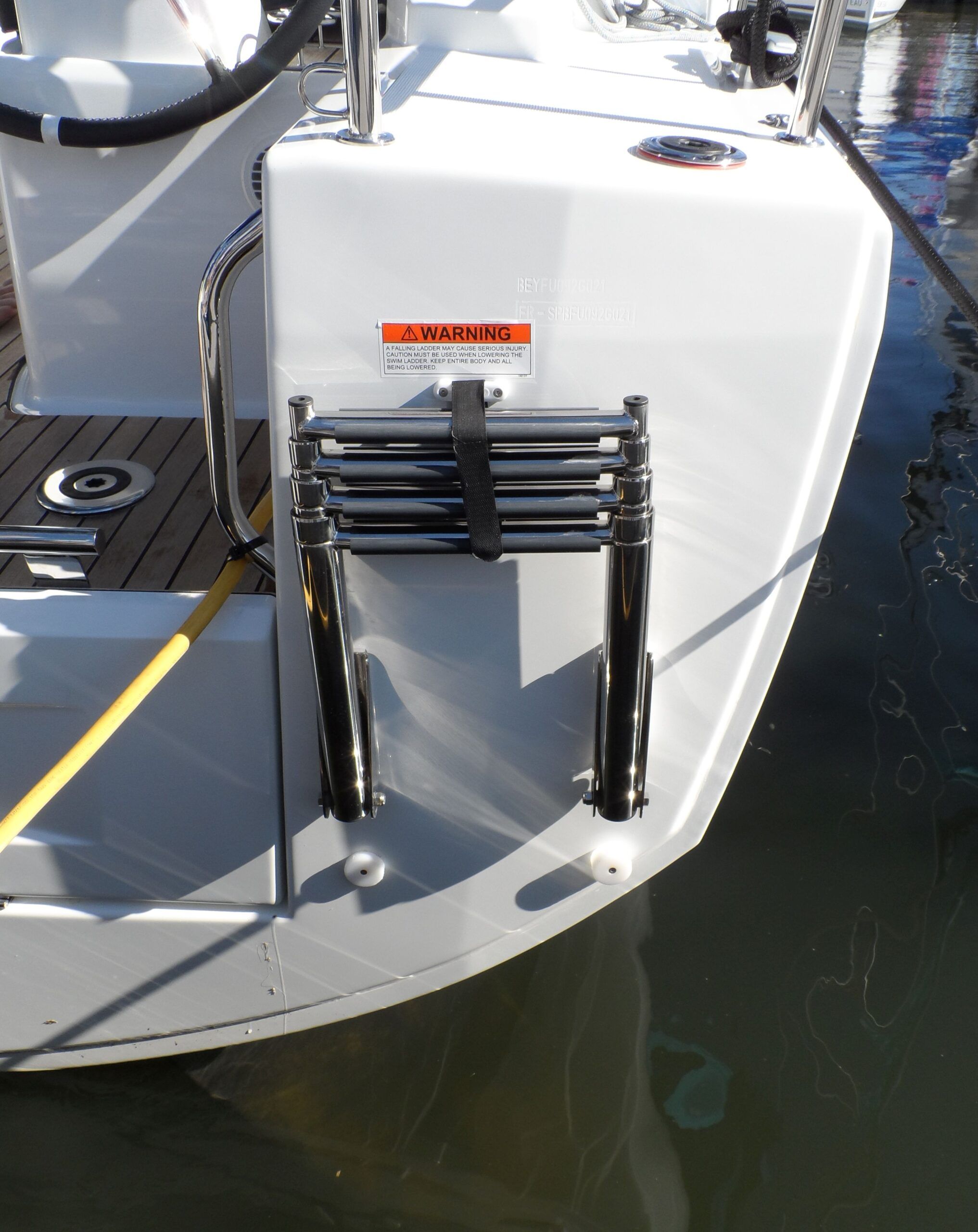 Boarding ladder. ABYC and ISO require them. I’ve fit them to the skinny little transoms of many multihulls, so don’t say it won’t fit. And add a third step. This is an Oceanis 30. (Photo/ Drew Frye)