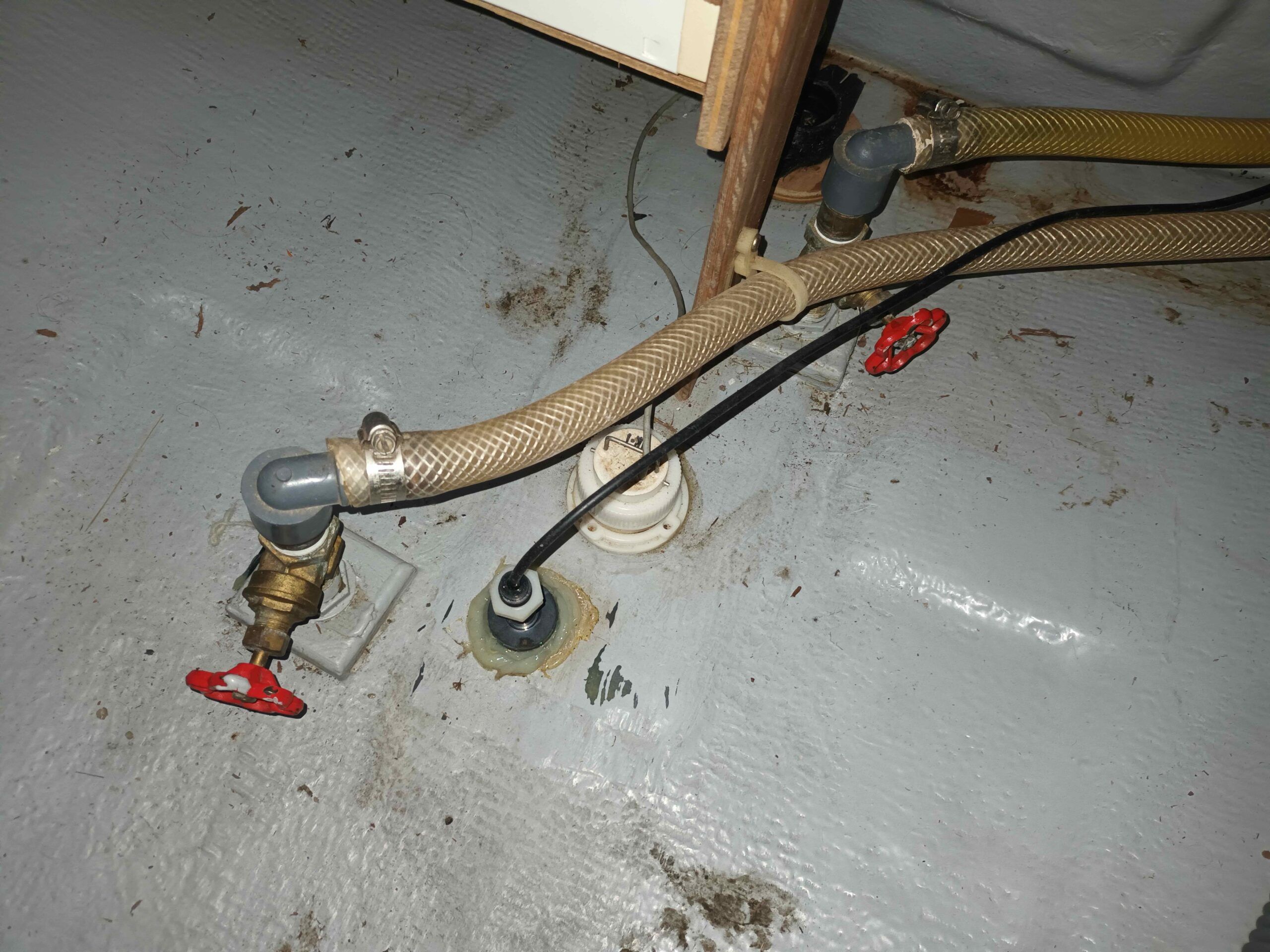 Gate valves should never be used under the water line. Any surveyor would recommend immediate removal and replacement with a proper seacock. These gate valves were non-functioning and were never replaced by the previous owner. The issue was reported in the marine survey fifteen years prior. This is a great way to sink your boat. (Photo/ Ray Ville)