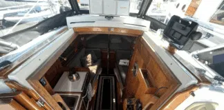 Despite her compact size, the Dana 24 offers genuine 6-ft. headroom in the saloon and sleeping space for two 6-ft. 2-in. adults in the V-berth. Hand-rubbed oiled teak surfaces, bronze ports, and the absence of a forward bulkhead creates surprising spaciousness. Courtesy of Yachtworld.com