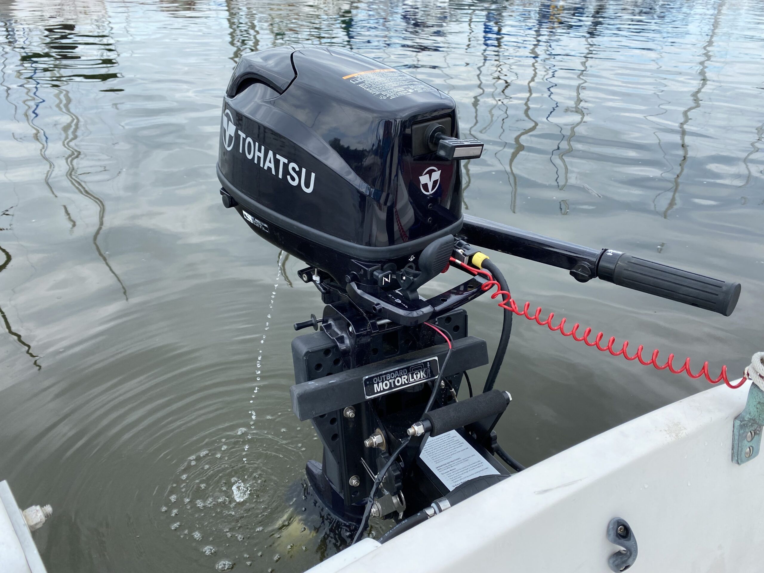 The author’s 6-hp Tohatsu SailPro sipped less than 10 gallons of gas for a total of 24 hours of use over the entire 2020 season. Compared to electric outboards the motor is loud, emits exhaust and requires maintenance, but it offers higher top speeds, far longer range and it generates, rather than draws, electricity. At this writing in 2025 it costs about $1,900, versus $4,200 to $5,996 for a comparable electric outboard with its recommended battery. (Photo/ Doug Henschen)