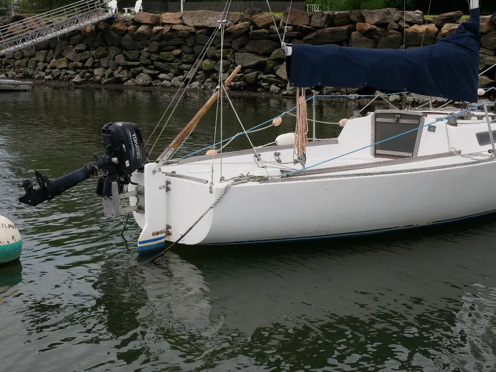 A J/22 with a 6 hp Tohatsu mounted on a bracket. Brackets raise and lower the motor by 10 inches or more, putting the prop deep in the water when motoring and raising it up well clear of the water when the motor is tilted. (Photo/ Doug Henschen)