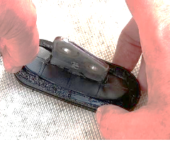 DIY chainplate seal: a rubber grommet glued to the deck around the chainplate and filled in with non-hardening roofing adhesive. (Photo/ Steve Milan)