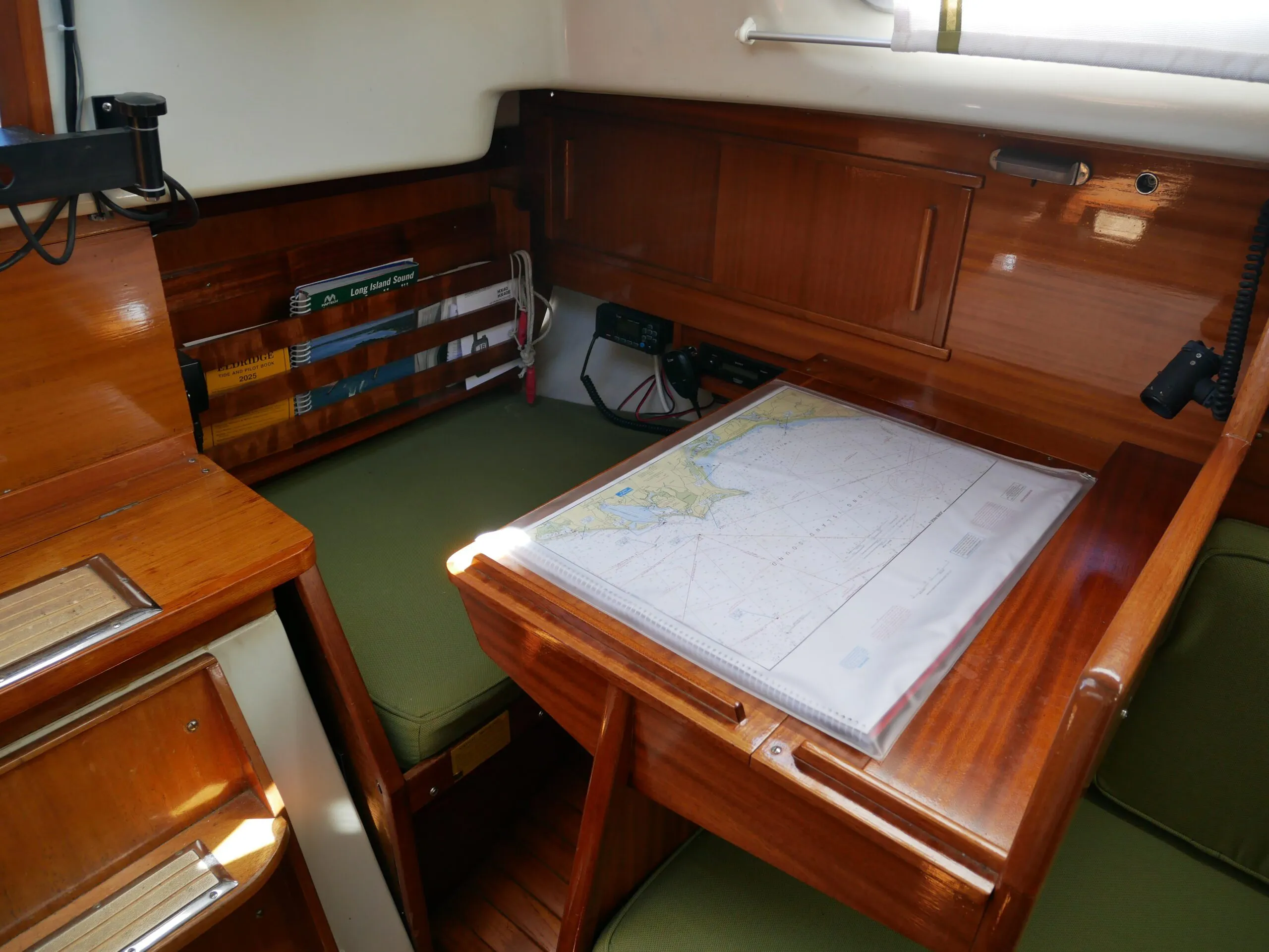 It’s a tight squeeze between the top step of the companionway and the corner of the navigation table, above, but there’s plenty of room once seated. (Photo/ Doug Henschen)