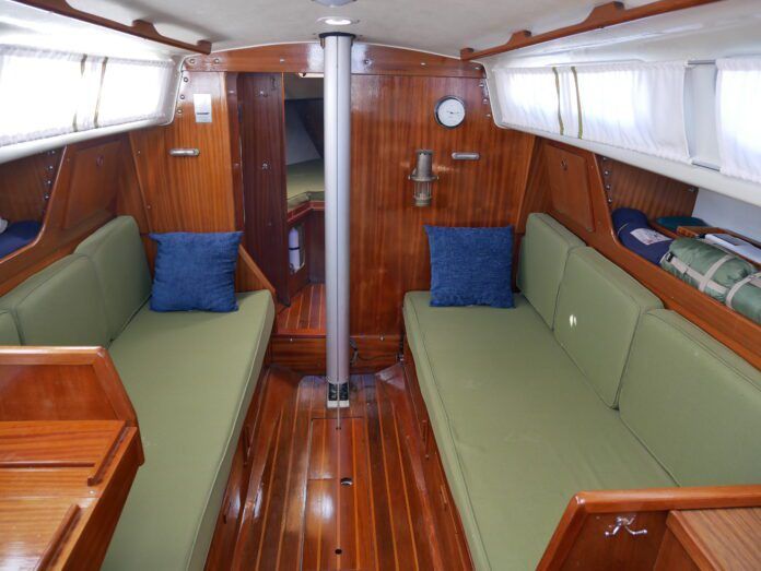 The Ballad salon offers plenty of light. Some models, like the one pictured, have upgraded teak and holly soles. Ventilation is limited to two passive overhead vents. Marius Draeger has upgraded his boat with opening rear windows, available from an aftermarket supplier in Denmark, the capital of Ballad ownership. (Photo/ Doug Henschen)