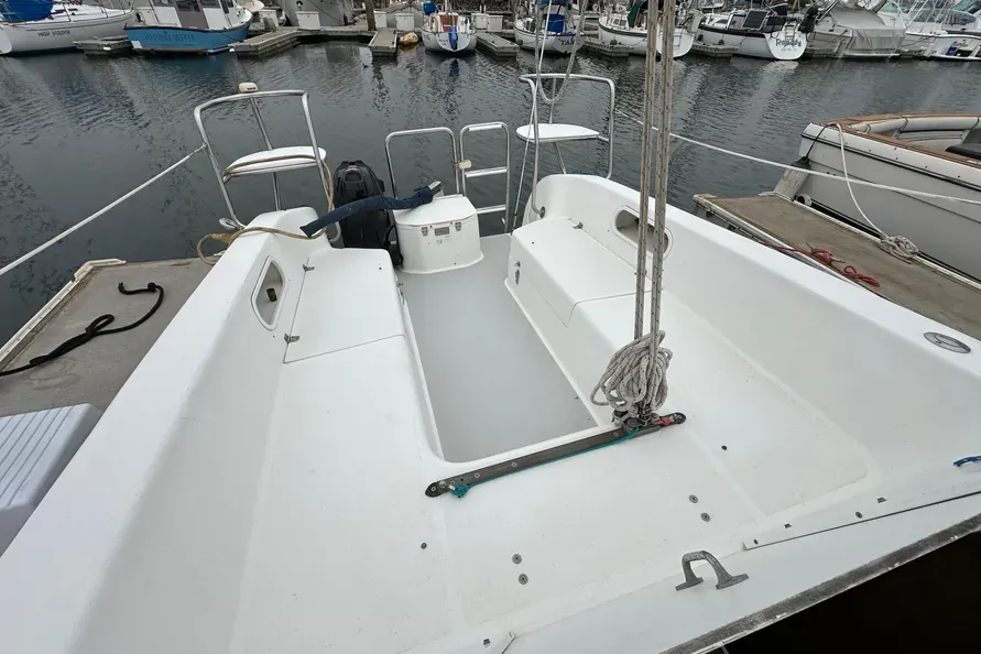 The Catalina 250's cockpit features an open transom with the outboard motor mounted in an accessible well forward of the stern. Jib sheet winches are positioned far forward in the cockpit—less than 9 in. from lifeline stanchions—making singlehanded tacking awkward, as the helmsperson must abandon the tiller to work the sheets. Courtesy of BoatTrader.com