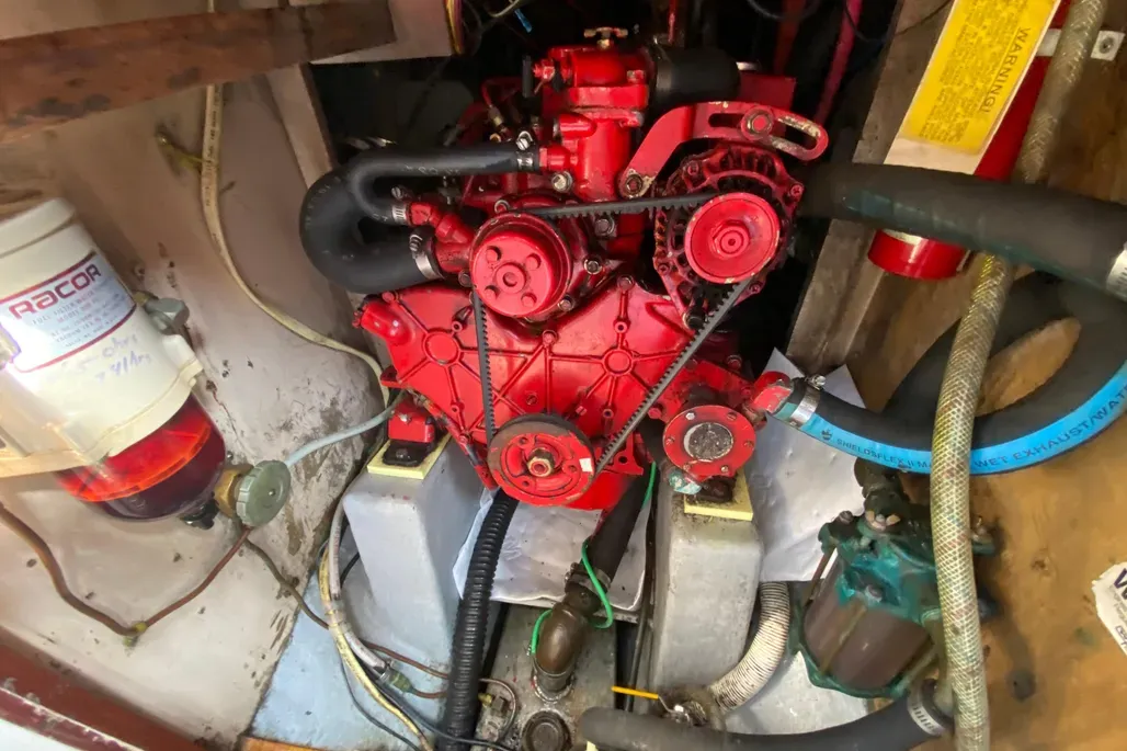 The Westerbeke 4-99 diesel, installed in over half of existing Pilots as a replacement for original gas engines, provides reliable cruising power at 6 knots or better, though steering in reverse remains difficult. Courtesy of YachtWorld.com