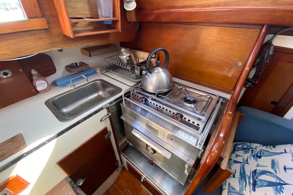 The galley reflects the quality craftsmanship found throughout the Pilot 35's interior, with efficient counter and stowage space designed to function well even in rough conditions. Courtesy of YachtWorld.com