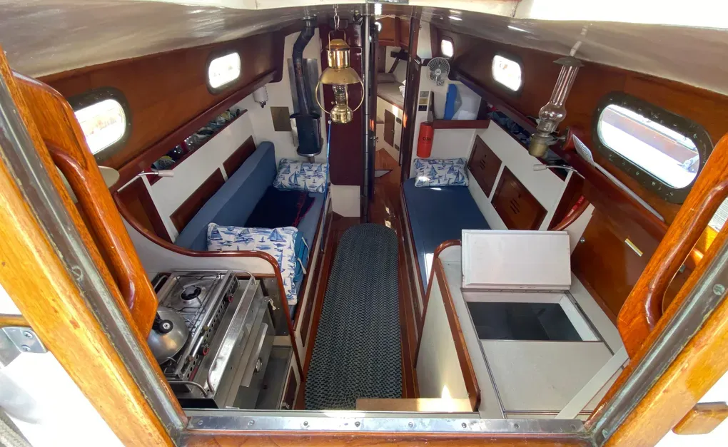 Hinckley sheathed the fiberglass hull with Philippine mahogany to create warm, traditional accommodations and banish the "ice box feel" common in early fiberglass designs. Courtesy of YachtWorld.com