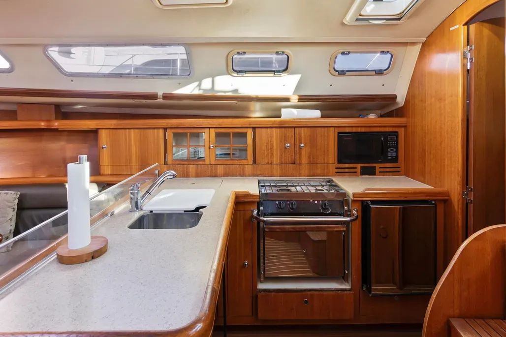 The L-shaped galley features Hunter's signature Corian countertops measuring 60-in. x 20-in., dual stainless sinks, and a two-burner stove/oven combination with optional refrigerator aft and slide-out storage forward. Courtesy of YachtWorld.com