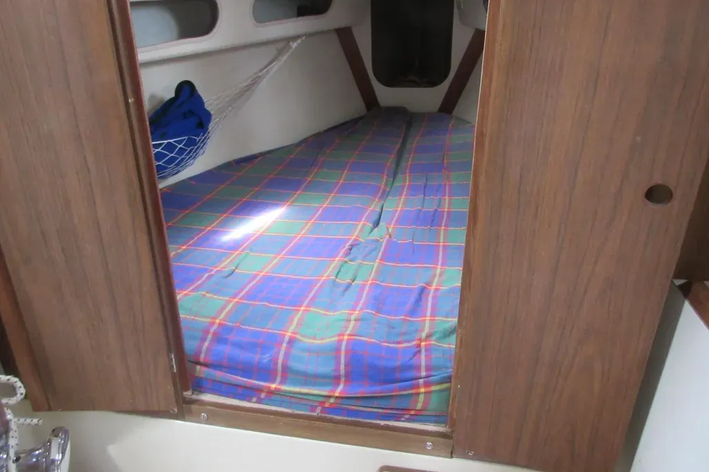The Pearson 30's forward cabin features a full-width V-berth with ample cushioning. The cabin can be closed off from the head by double doors, providing privacy for crew. Courtesy of YachtWorld.com