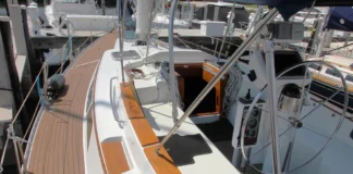 The freestanding 62-ft. carbon fiber mast eliminates the rigging maintenance typical of stayed rigs, with the thicker aerodynamic profile engineered to flex under load like an aircraft wing—spilling wind in gusts and providing stability without shrouds or stays. Photo courtesy of YachtWorld.com