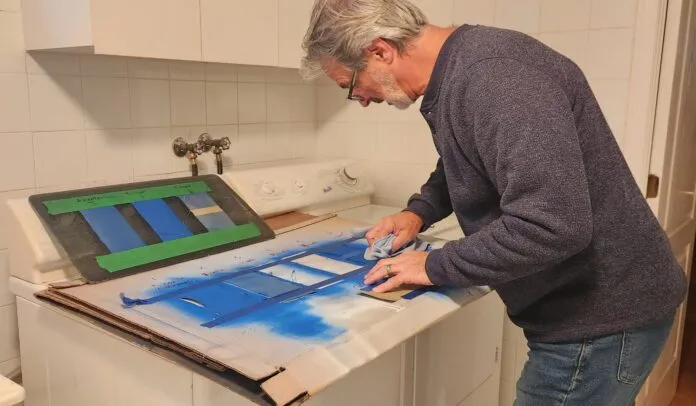 Author doing a rub and chemical test on samples Author doing a rub test and chemical test on samples of canvas painted with exterior fabric paint. (Photo/ Marc Robic)