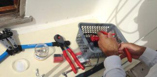 Stripping wire and crimping the lugs on for the lithium conversion. (Photo/ Nicholas Koiter)