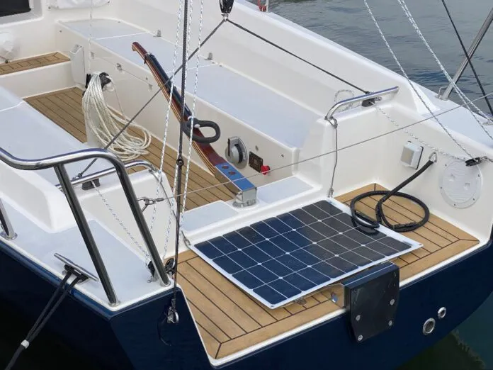 A J/Boats J/9 powered by the optional Torqeedo Cruise 6.0 pod drive, which is mounted in place of a saildrive. The throttle and battery monitor panel are visible on the starboard bench seat. The optional solar panel helps top up the battery when away from dockside power. (Photo/ Doug Henschen)