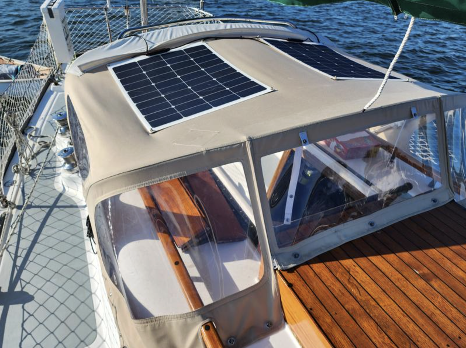 The teak hatch and well-maintained brightwork exemplify the quality joinery typical of these boats. Courtesy of SailboatListings.com