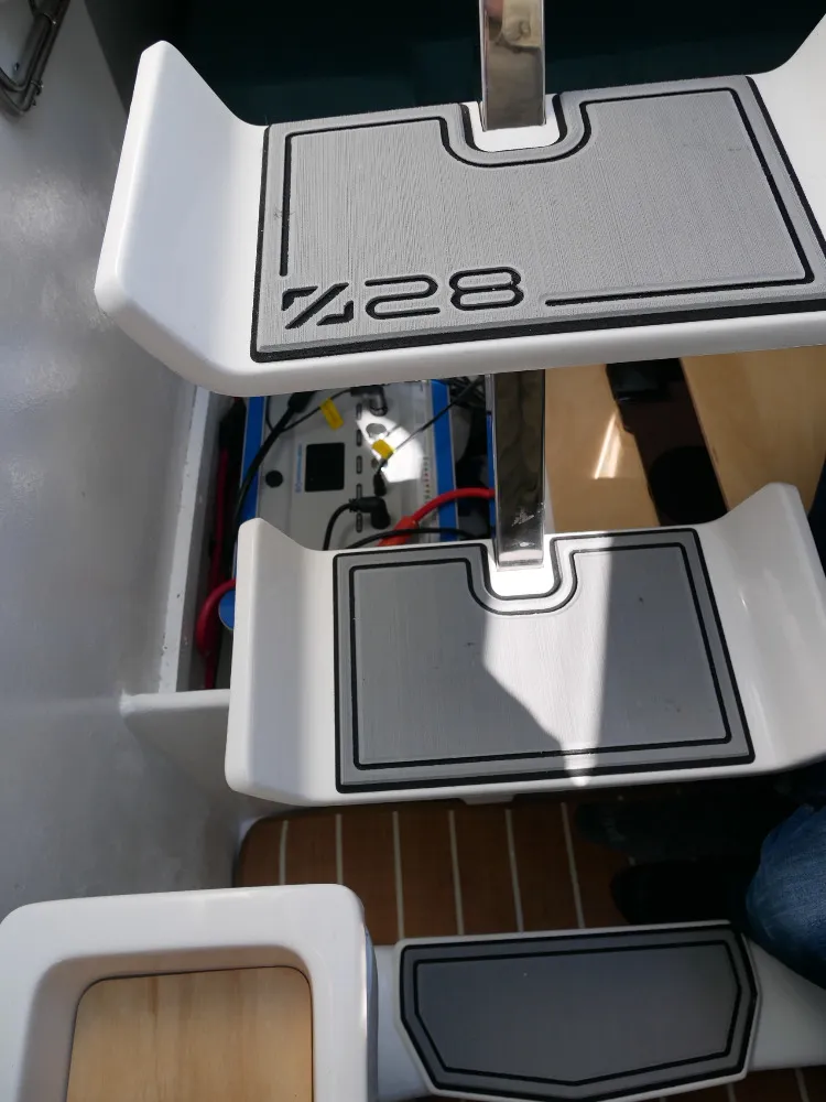 A shot of the Z28 companionway steps reveals the pod drive battery (a 48 volt/3072 watt hour ePropulsion E60) installed in its usual spot in the space that would otherwise be occupied by a diesel inboard atop the saildrive. (Photo/ Doug Henschen)