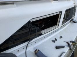 Removing the frameless windows from a Hunter. The plexiglass fractured before releasing from the sealant. (Photo/ Bert Vermeer)