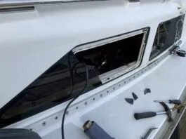 Removing the frameless windows from a Hunter. The plexiglass fractured before releasing from the sealant. (Photo/ Bert Vermeer)