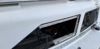 Removing the frameless windows from a Hunter. The plexiglass fractured before releasing from the sealant. (Photo/ Bert Vermeer)