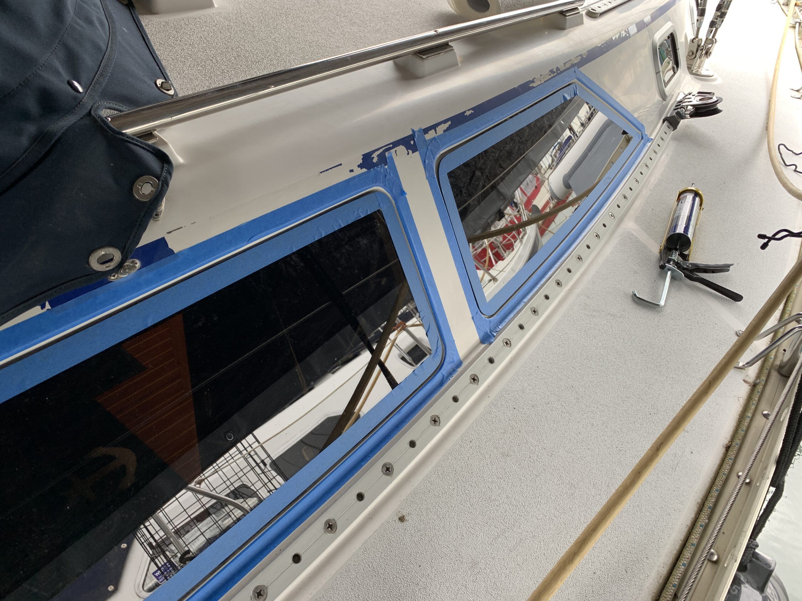Ready for the Sikaflex sealant as a fill-in for the gap around the plexiglass. Masking tape to protect the gelcoat. (Photo/ Bert Vermeer)