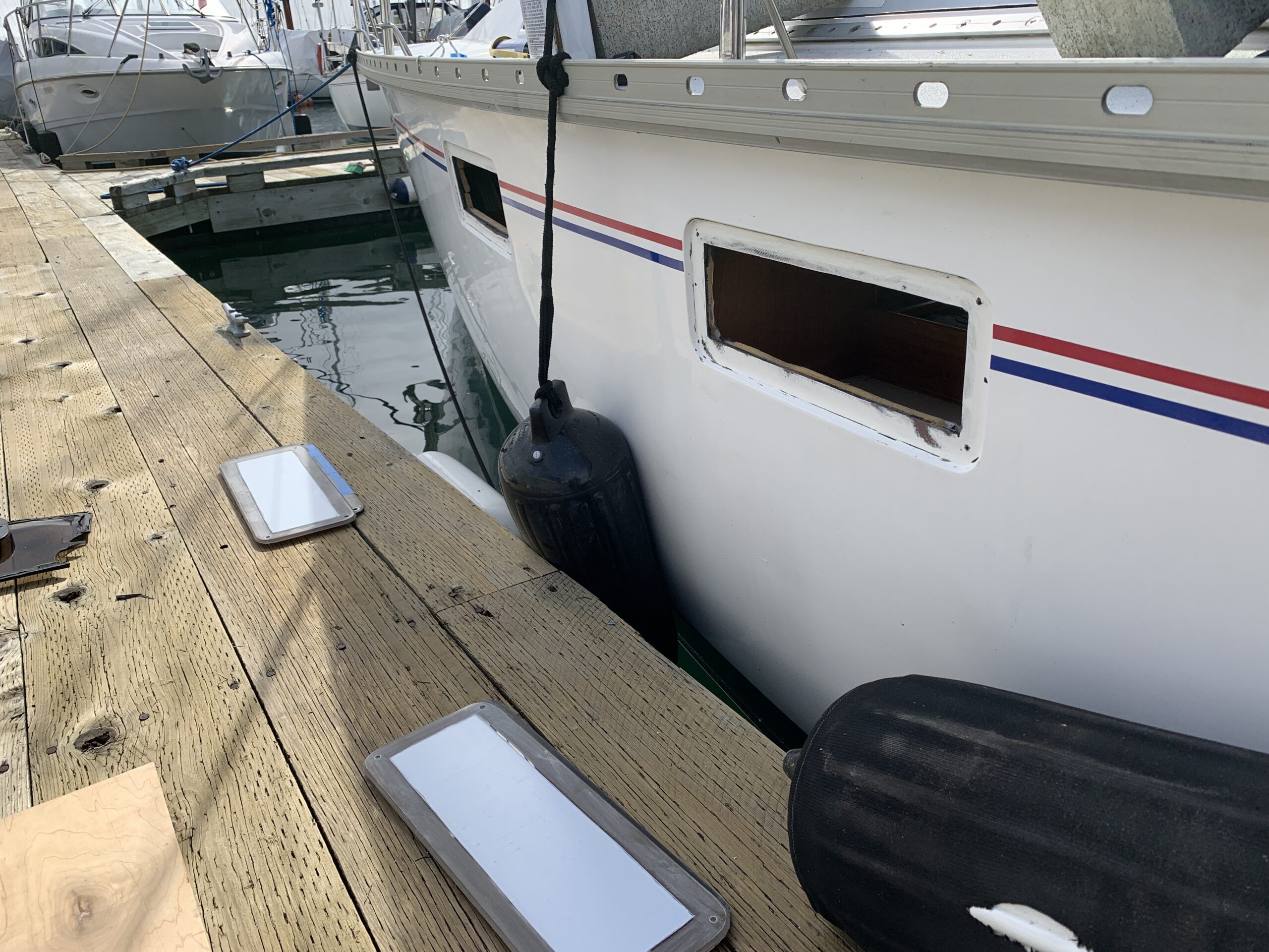Hull portlights on the Hunter. The old portlights are removed, the gelcoat is clean with the replacement plexiglass ready for installation. (Photo/ Bert Vermeer)
