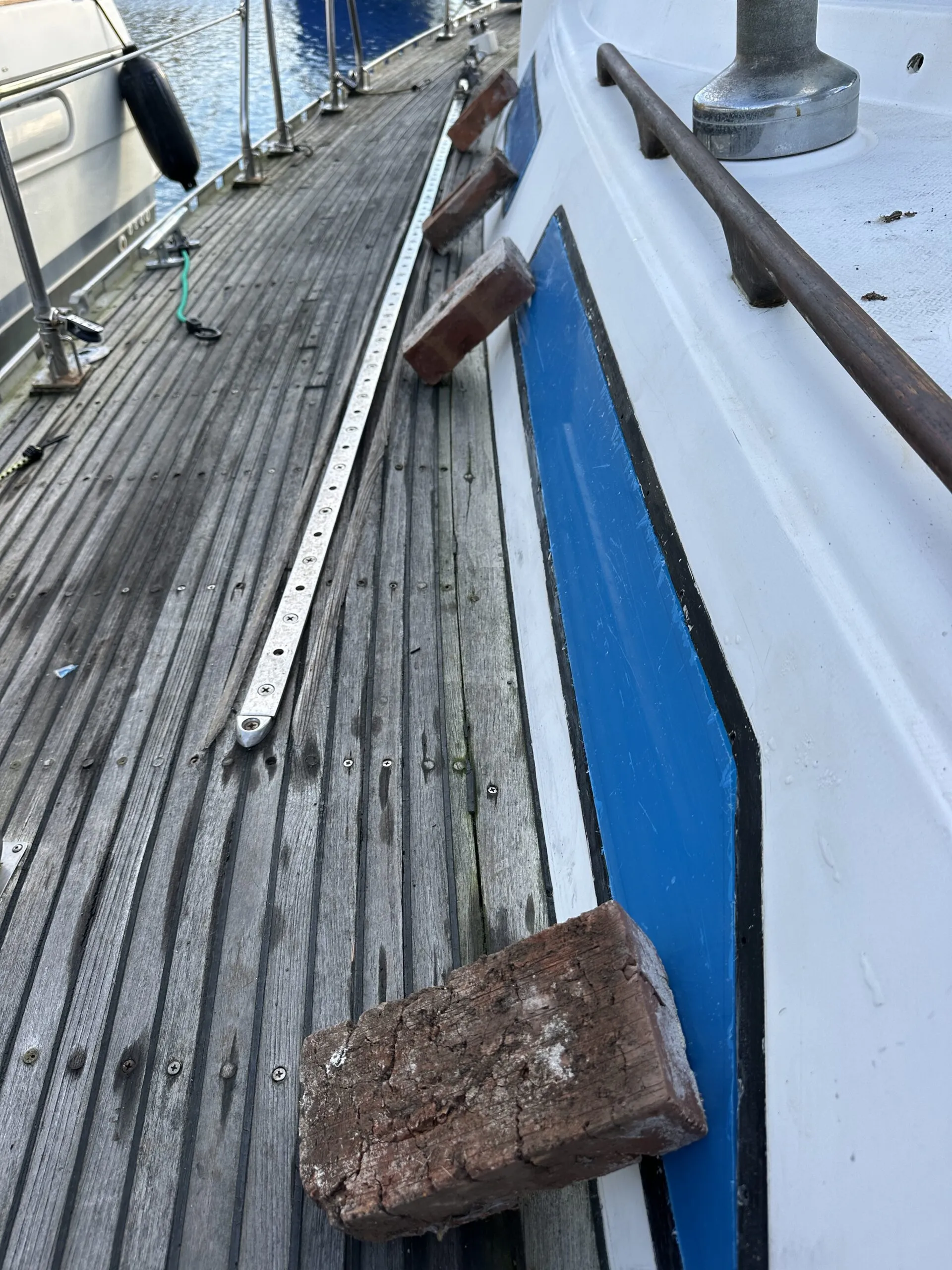 The protected plexiglass is in place with bricks holding it still so that the inside can be marked for plastic removal. (Photo/ Bert Vermeer)